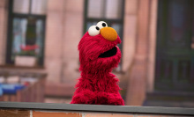 Picture of Elmo standing at a desk