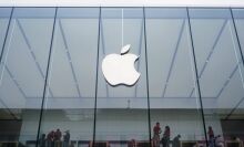 Apple logo prominently featured on the face of an Apple Store