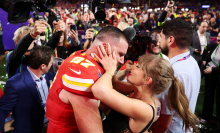Travis Kelce and Taylor Swift celebrating on the field after the Super Bowl.