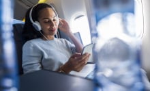 woman using headphones on an airplane