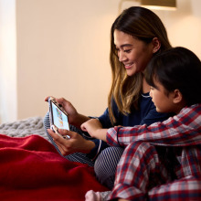 A young woman and child play the nintendo switch together