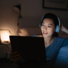 woman watching streaming service on a laptop