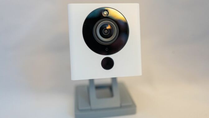 A surveillance camera from smart home company Wyze isolated on white background.