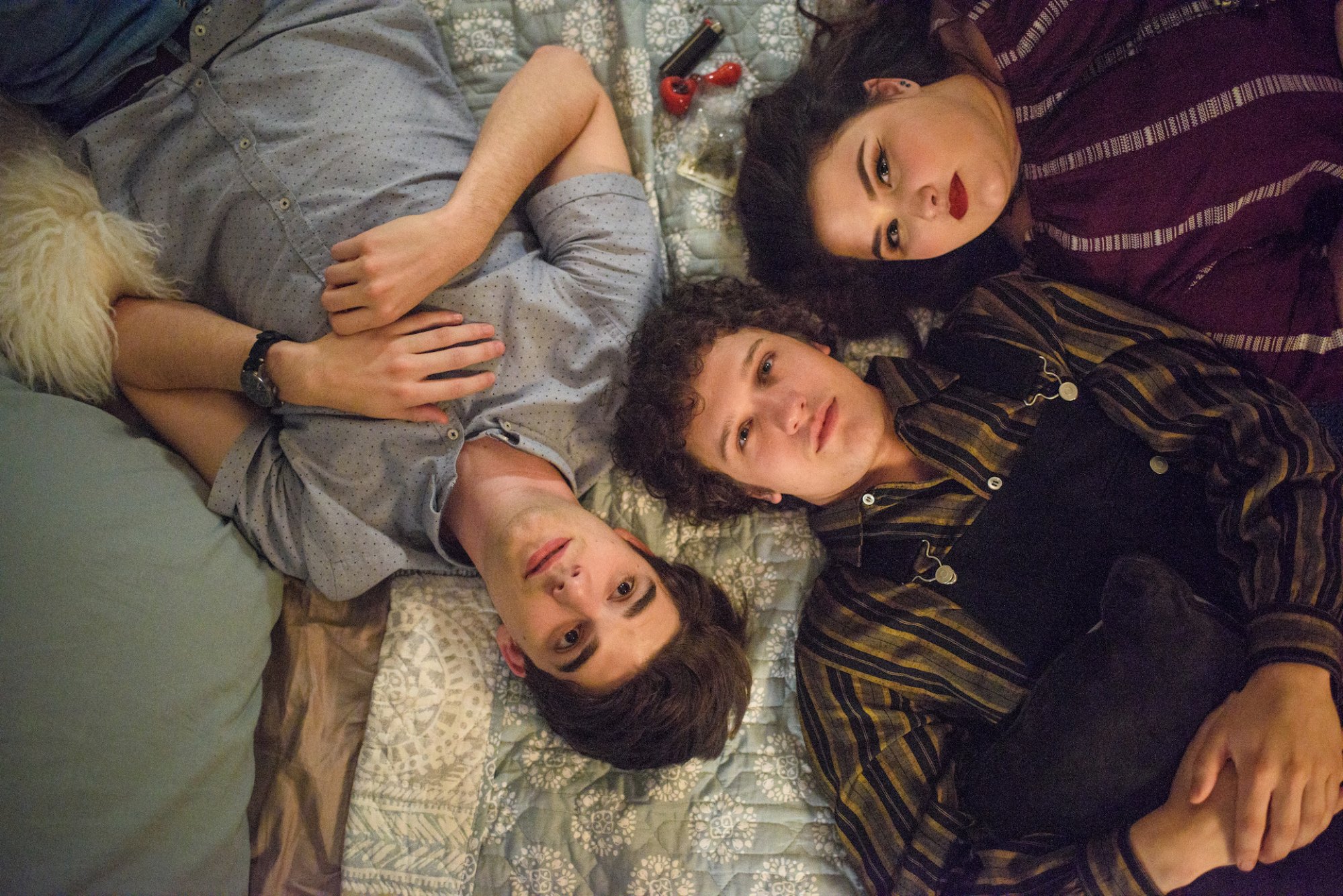 A scene from "Alex Strangelove": teens hanging out on a bed