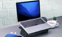 macbook sitting on elevate laptop stand on desktop