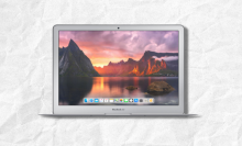 refurbished macbook air with screen open and white textured background