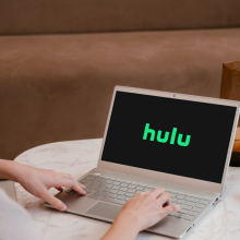 woman watching Hulu on laptop