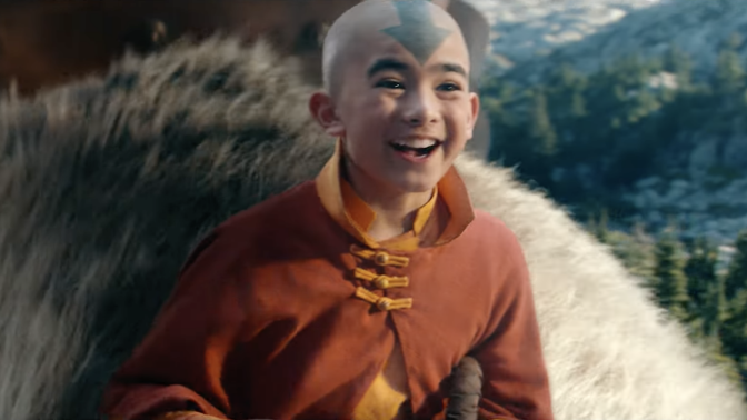 A screenshot from the final trailer of the live action "Avatar: The Last Airbender." Aang is smiling as he rides his sky bison.